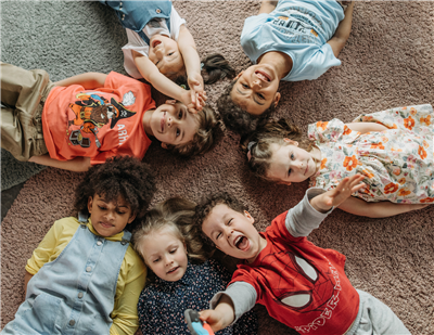 kids lying on carpet